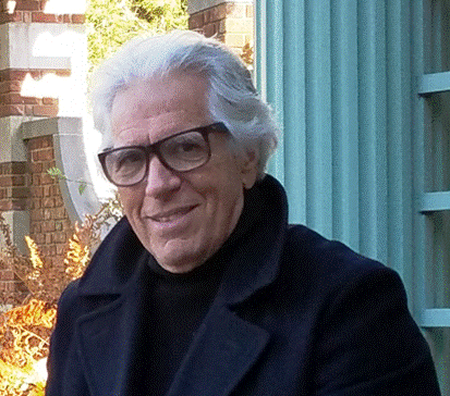 A person sitting in front of a building

Description automatically generated