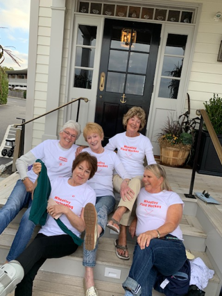 A group of people sitting on a porch

Description automatically generated with medium confidence