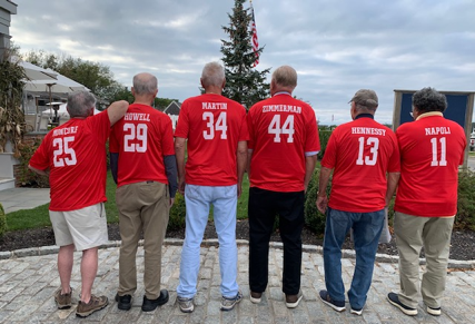 A group of men in red shirts

Description automatically generated with low confidence