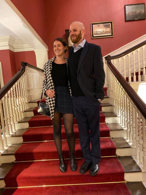 A person and person posing for a picture on a staircase

Description automatically generated with medium confidence