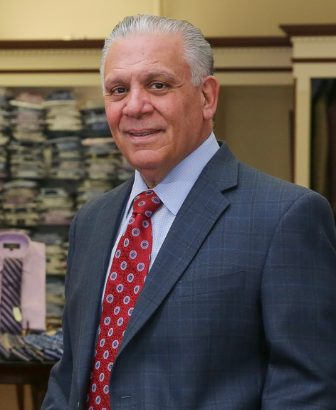 A person in a suit and tie

Description automatically generated with medium confidence