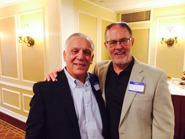 A couple of men posing for the camera

Description automatically generated with medium confidence