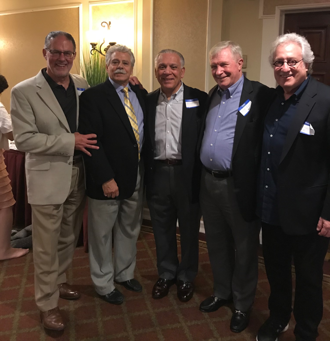 A group of men posing for a photo

Description automatically generated