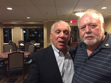 A couple of men posing for the camera

Description automatically generated with medium confidence