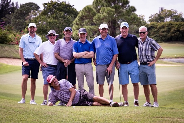 A group of men standing on a golf course

Description automatically generated with medium confidence