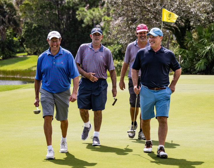A group of men walking on a golf course

Description automatically generated with medium confidence