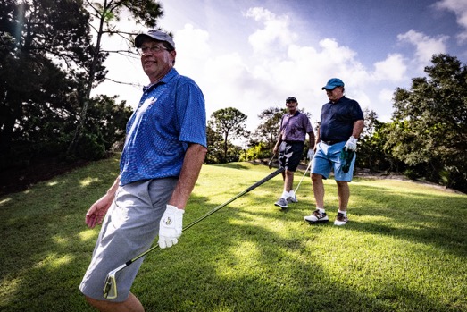 A group of men playing golf

Description automatically generated with medium confidence