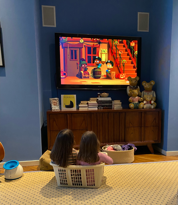 Two girls sitting in front of a television

Description automatically generated with low confidence